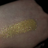 Eye shadow swatch, gold glitter, iridescent shimmer, on skin