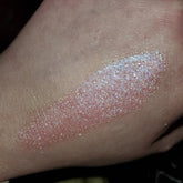 Close-up of shimmering bronze eye shadow palette with gradient tones in sleek black compact