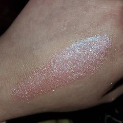 Close-up of shimmering bronze eye shadow palette with gradient tones in sleek black compact