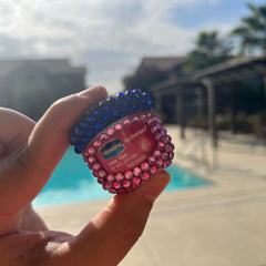 Lip therapy jar with pink and blue rhinestones, Vaseline brand visible, held in hand