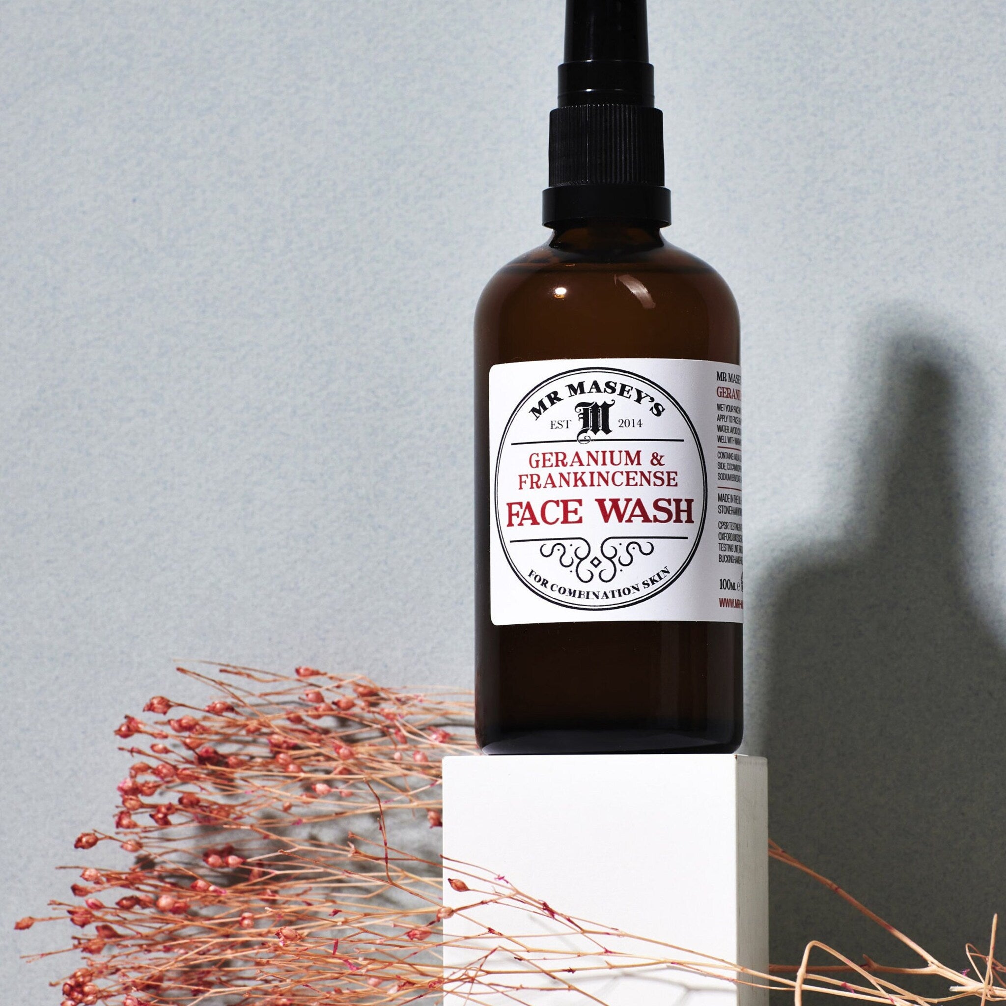 Face wash bottle brown glass with black pump and Mr. Masey's label on white block