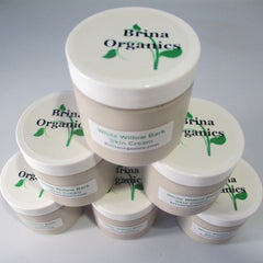 Skin cream jars, white lids, beige containers, Brina Organics branding visible on top