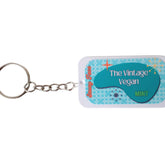Mint lip balm with teal and white design, "The Vintage Vegan" text, and metal keychain