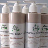 Body cream bottles with white pump tops, light brown color, and Brina Organics labels