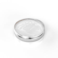 Cream jar with white cream and silver metal container on white background
