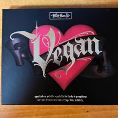 Eyeshadow palette with pink heart, black background, and Kat Von D Vegan text design