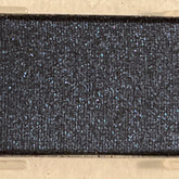 Close-up of Mineral Eye Shadow in Starry Night showing deep navy blue powder with shimmering silver flecks in compact case