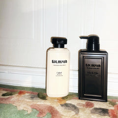 Face wash bottles, white and black rectangular bottles with black pump tops, brand name visible