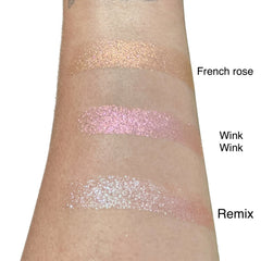 Two duo chrome eyeshadow pans showing color shift from bronze to green in minimalist packaging