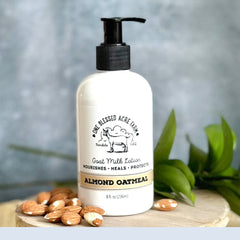 Lotion bottle with black pump, white label, and almond oatmeal text, by One Blessed Acre Farm