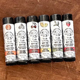 Lip balms with black caps, white label, and illustrations, One Blessed Acre Farm brand