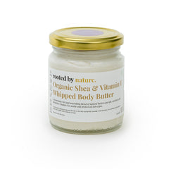 Side view of golden jar with whipped shea butter, showcasing rich texture and organic cocoa flecks