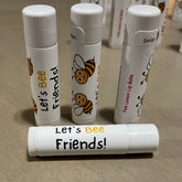 Lip balm tubes with white and bee design, "Let's Bee Friends!" text, Sweet Honey Farm brand