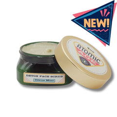 Men's face scrub in green glass jar with gold lid, Atomic Age brand name visible