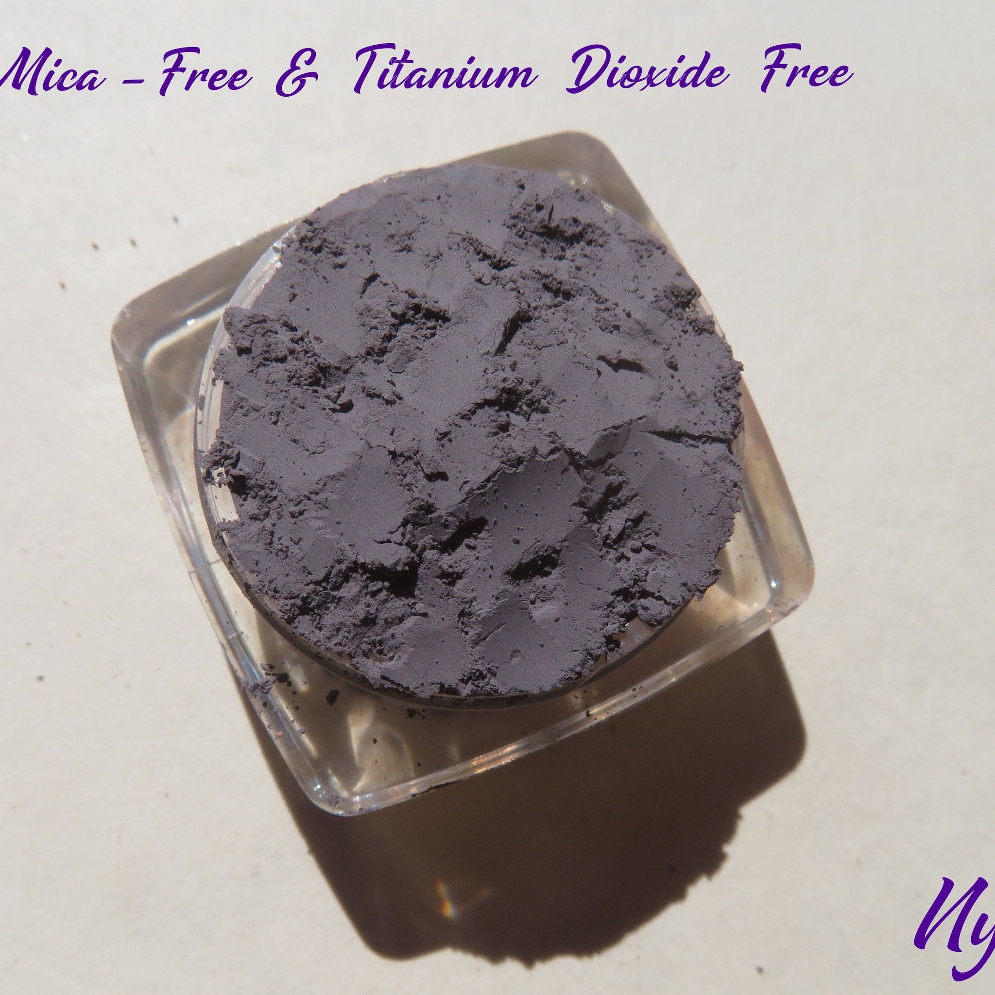 Eyeshadow pigment, matte medium gray, loose powder in clear container