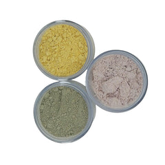 Loose powder makeup in yellow, pink, and green colors, in clear jars