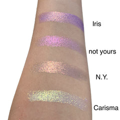 Side view of duo chrome eyeshadow pan showcasing metallic color shift from bronze to green