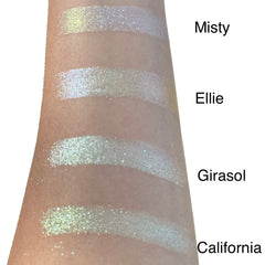 Close-up of duo chrome eyeshadow pan showing shifting iridescent hues from gold to pink