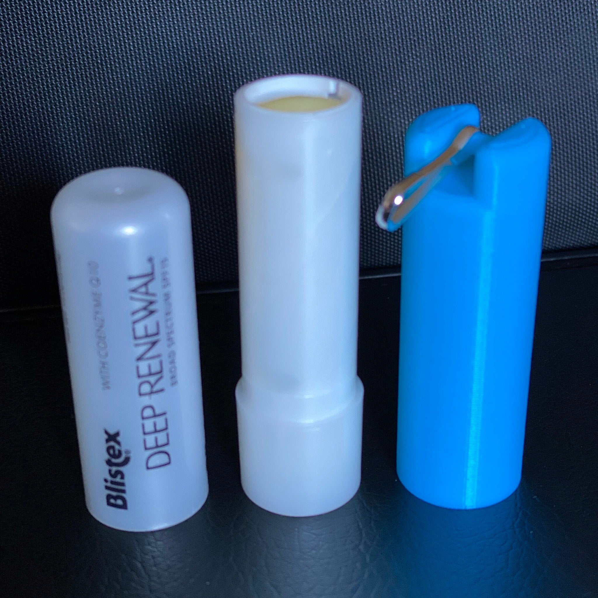 Lip balm holder, white and blue plastic, Blistex Deep Renewal with lip balm visible