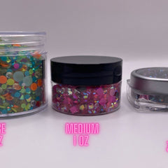 Rhinestone jars with clear, pink, and multi-colored gems in clear containers with black and silver lids