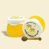 Lip balm jars with yellow and white lids, Genki Skincare branding, and a small honey dipper