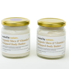 Close-up of whipped shea butter texture in white ceramic jar with gold lid, showcasing rich creamy consistency