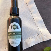 Facial toner bottle, black glass, white label, Bear Faced skincare brand