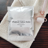 White recyclable jar of whipped grass-fed tallow balm with minimalist label and creamy texture