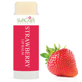 Strawberry lip balm tube with red label, white text, and fresh strawberry fruit