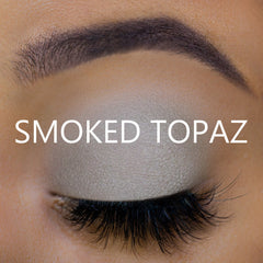 Eyeshadow with gray-beige color, matte finish, and "SMOKED TOPAZ" text on eye