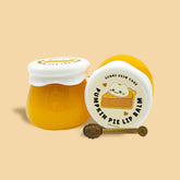 Lip balm jars, yellow and white, with Genki Skin Care label and honey dipper