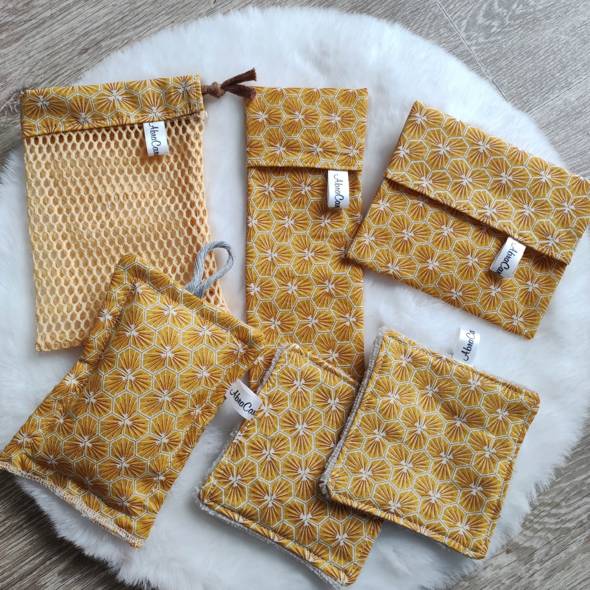 Eco-friendly beauty kit with bamboo soap net, reusable sponge, and sleek travel cases on marble surface