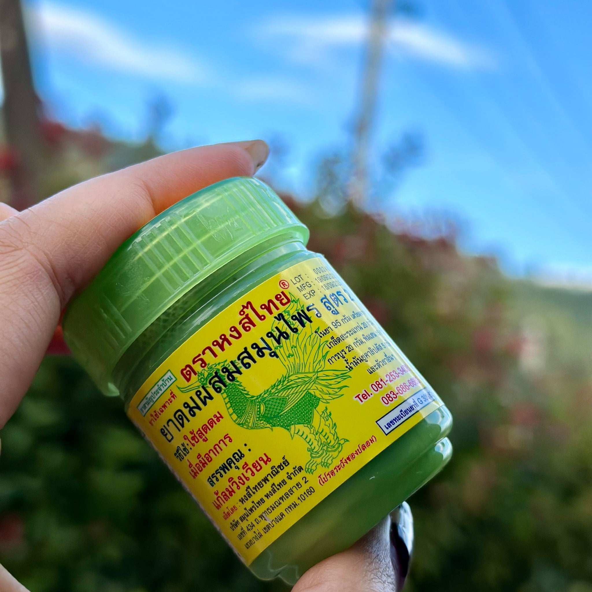 Steam inhaler, green plastic bottle with yellow label, held in hand, Hongthai brand