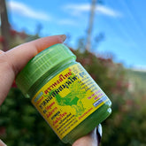 Steam inhaler, green plastic bottle with yellow label, held in hand, Hongthai brand