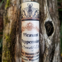 Lip balm tube with bee graphic, cream and brown label, and Pleasant Peppermint text