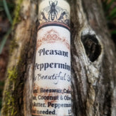 Lip balm tube with white and brown label, Pleasant Peppermint text, and bee illustration