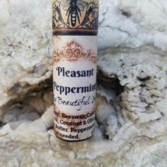 Lip balm tube with brown floral pattern, black text, and bee illustration