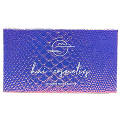 Close-up of 18 vibrant pressed glitter eye shadow pans in a palette, showcasing shimmering metallic and matte finishes