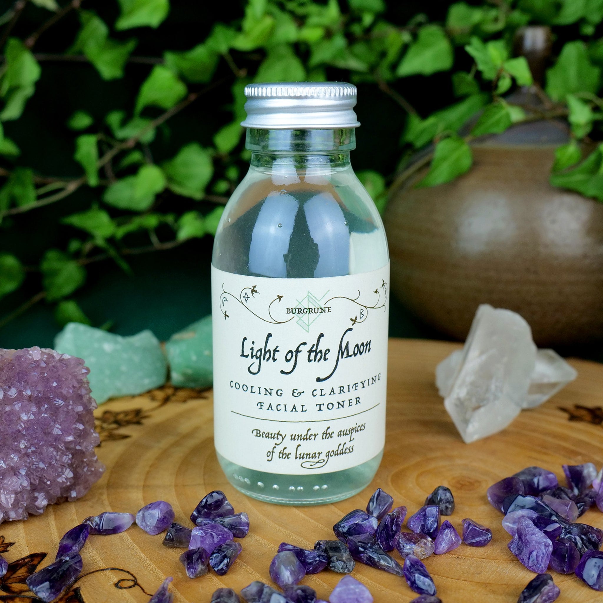 Toner bottle with silver cap, clear glass, and Burgrune's label on wooden surface