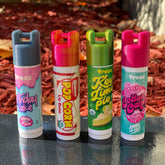 Lip balm holders, 3D printed with various colors and Treat brand name visible, in use