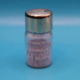 Powder eyeshadow in a glass jar with a silver cap, featuring "Number Seven" text