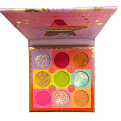 Eyeshadow palette with pink and gold accents, star shaped lid, and colorful eyeshadows inside.