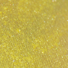 Side view of small glass jar with black sifter lid containing pigmented mineral eye shadow powder