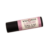 Lip balm tube with black base, pink floral label, and Wild Rose text visible