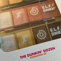 Eyeshadow palette with multiple colors, E.L.F. DNKN text, and white donut and runner icons on the palette
