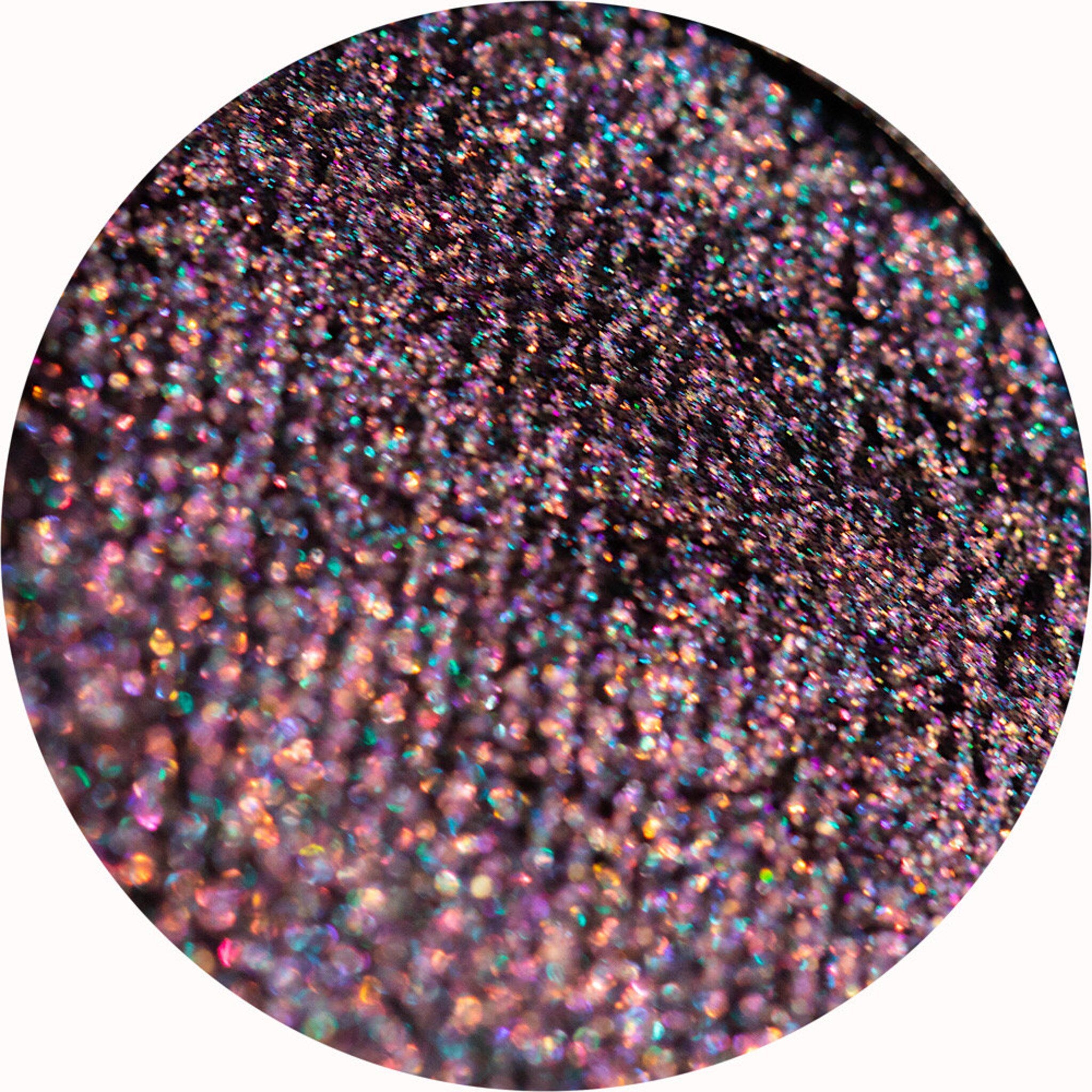 Vibrant pink and silver eye shadow palette with geometric packaging design, showcasing shimmering shades in rectangular pans.