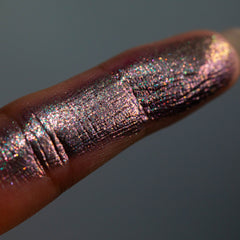 Close-up of shimmering pink and gold eye shadow palette with geometric pan designs and glossy packaging