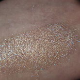 Close-up of Stay Cool, Bret Eye Shadow in a sleek black compact with vibrant teal powder shimmer.