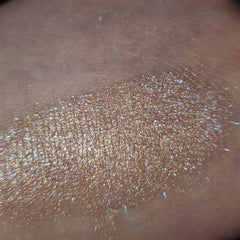 Close-up of Stay Cool, Bret Eye Shadow in a sleek black compact with vibrant teal powder shimmer.