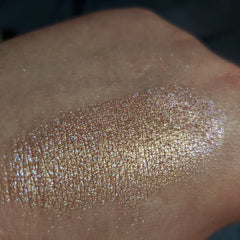 Side view of Stay Cool, Bret Eye Shadow compact showing sleek black case and shimmering teal powder texture